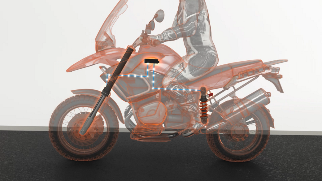 The image shows various body control units inside a transparent motorcycle. As a central component of modern motorcycle architecture, our Body Control Unit manages a wide range of functions, from lighting to HMI control, immobilization, and heating.