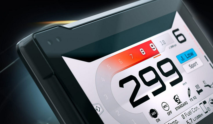 Close-up of an AUMOVIO TFT display for motorcycles. Aumovio offers a range of high-performance instrument displays tailored for motorcycles, designed to offer maximum flexibility. It employs automotive-grade technology with optical bonding for crystal-clear visuals. 