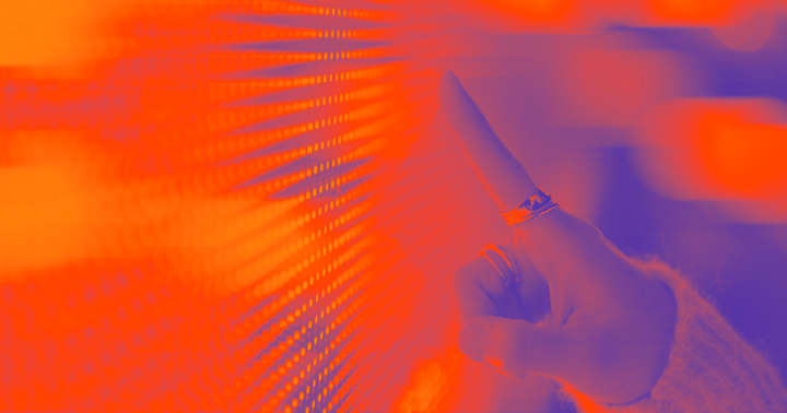 Female hand touching illuminated orange digital screen. Technology and innovation. Connecting to the future.