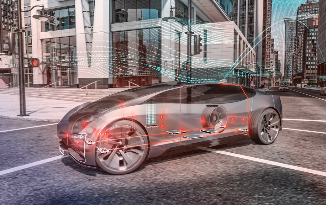 Bild des halbtransparenten AUMOVIO-Konzeptfahrzeugs an einer Kreuzung in der Stadt mit orange hervorgehobenen Steuergeräten im Fahrzeug. Der Geschäftsbereich Architecture and Network Solutions (ANS) konzentriert sich auf die wichtigsten Anforderungen softwaredefinierter Fahrzeuge..