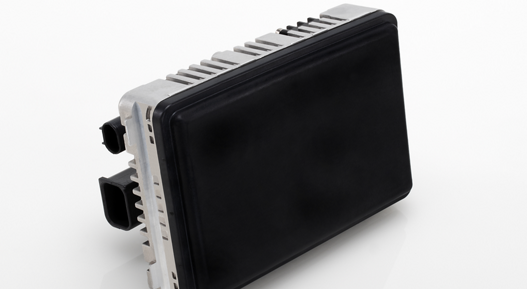 Black radar sensor with dual connectors and robust casing for vehicle safety systems.