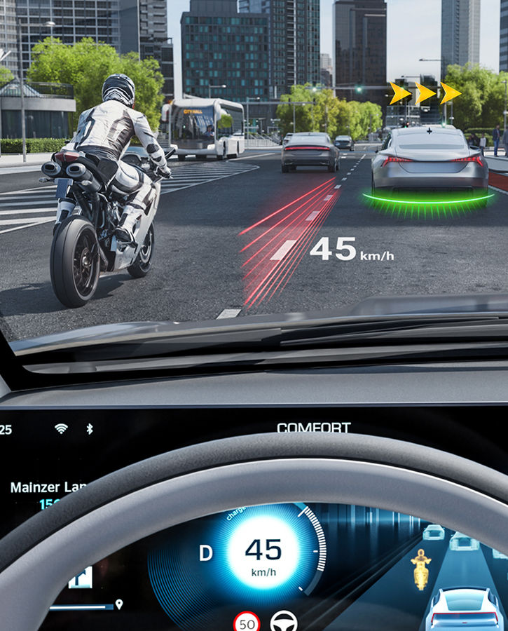 Image through the windshield showing a traffic situation. A head-up display shows a wide variety of traffic information projected onto the surroundings. HUD ARCreator  projects essential driving information directly onto the windshield into the driver’s line of sight, ensuring drivers keep their eyes on the road. 