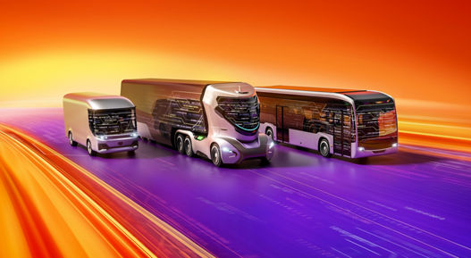 Three futuristic autonomous commercial vehicles driving along a digital highway on AUMOVIO background.