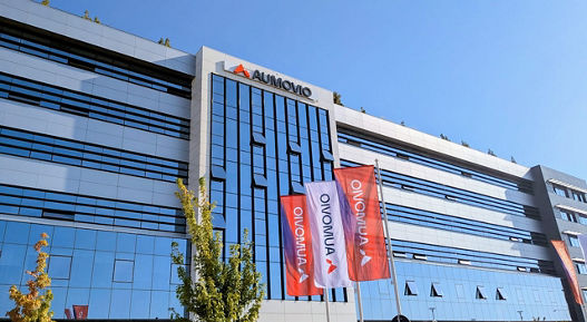 A photo of a building with a large AUMOVIO logo and AUMOVIO flags in front of it. We are the go-to partner for comprehensive testing and analysis services for electronic and mechatronic components – supporting our clients globally and across the entire product lifecycle.