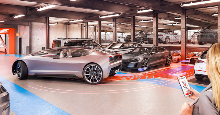A woman uses her smartphone to automatically move a futuristic vehicle out of its parking space in a parking garage.