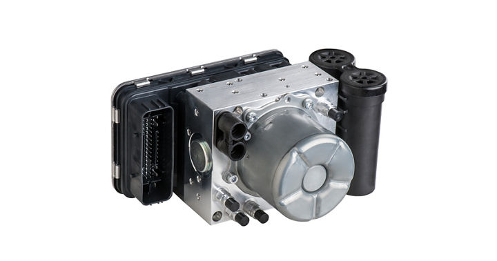 Automotive compressed air reservoir system consisting of a metallic housing with cylindrical components and multiple black connectors. The design includes integrated valves and mounting points for pneumatic suspension or braking applications.