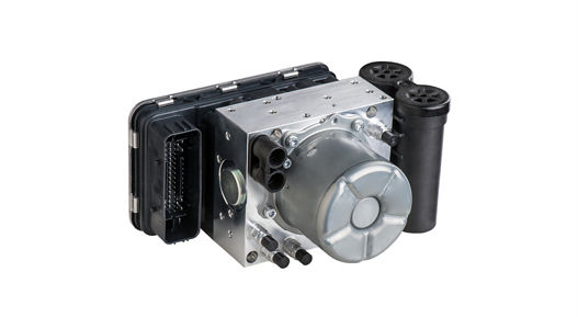 Automotive compressed air reservoir system consisting of a metallic housing with cylindrical components and multiple black connectors. The design includes integrated valves and mounting points for pneumatic suspension or braking applications.