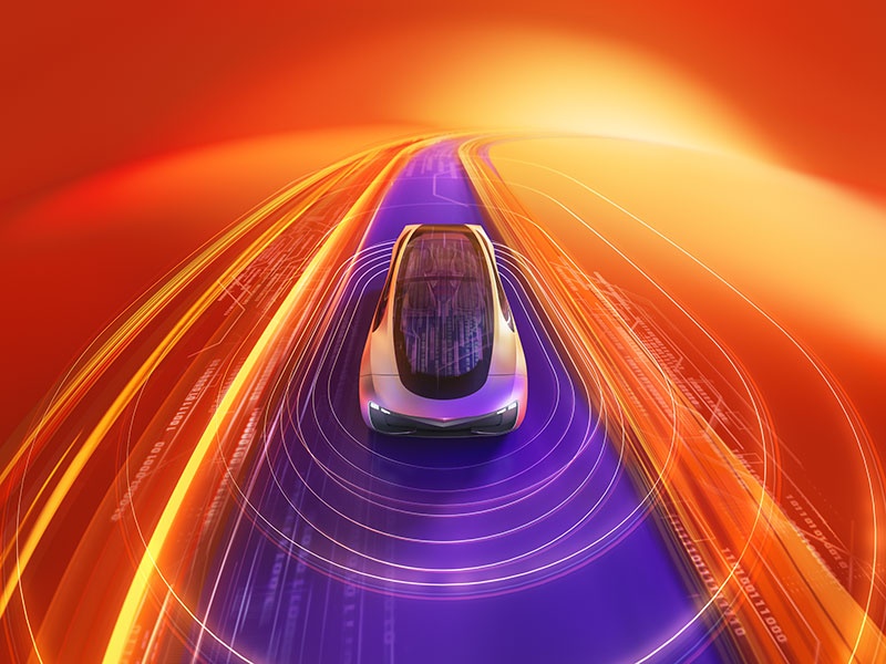 A futuristic car driving on a glowing digital road with vibrant orange, yellow, and purple light trails, representing advanced technology and the future of autonomous mobility.