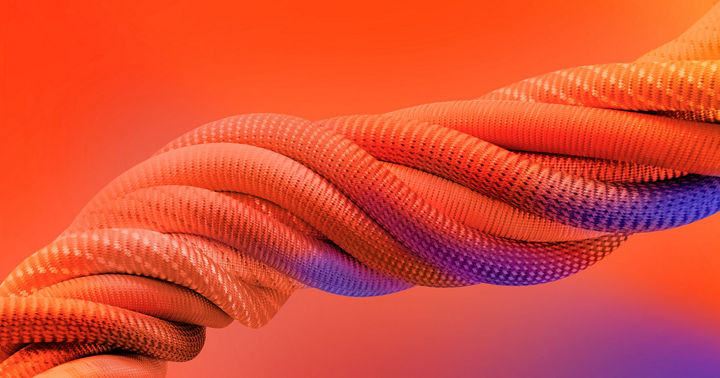 Close-up of a thick, twisted rope-like structure with a textured surface in vibrant orange tones, accented with purple highlights, set against a bright orange gradient background.