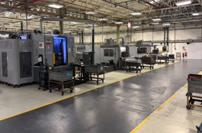 The image shows machines on a production line for CNC machining. Find out how AUMOVIO UK’s 30 high-precision, quick-changeover CNC machines (vertical lathes and horizontal milling machines with 3-, 4-, and 5-axis capabilities) can support your operations.
