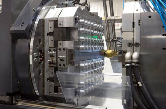 The image shows an injection molding machine. Find out how AUMOVIO UK can support you with their current machines, which are equipped with general-purpose screws suitable for most applications.