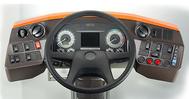Picture of Driver's Workplace+. It combines all the advantages and features of the proven Driver's Workplace Classic with a fresh design and modern functionality. It features a multifunctional instrument cluster with a 12.3-inch TFT color display, offering customizable scaling options. For seamless integration with the bus interior, interchangeable pads are available. Additionally, the workplace includes an accessory holder and a universal socket, optionally suitable for devices such as mobile phones.