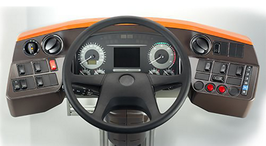 Picture of Driver's Workplace+. It combines all the advantages and features of the proven Driver's Workplace Classic with a fresh design and modern functionality. It features a multifunctional instrument cluster with a 12.3-inch TFT color display, offering customizable scaling options. For seamless integration with the bus interior, interchangeable pads are available. Additionally, the workplace includes an accessory holder and a universal socket, optionally suitable for devices such as mobile phones.