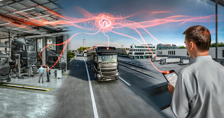 Connected fleet management concept showing heavy-duty trucks in a modern service workshop and on a highway. A person monitors vehicle data on a tablet while cloud-based connectivity is visualized with red digital lines linking trucks to a central cloud icon. The scene combines indoor maintenance and outdoor logistics under bright daylight.