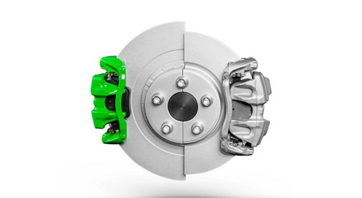 Close-up view of a green electric brake caliper featuring integrated electronic and hydraulic components. The vibrant color highlights its application in performance or concept vehicles.