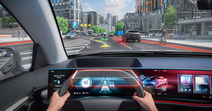 Image of a futuristic vehicle interior with a view through the windshield. Navigation, traffic, and warning information are projected directly onto the windshield via a head-up display, precisely where the driver needs it.