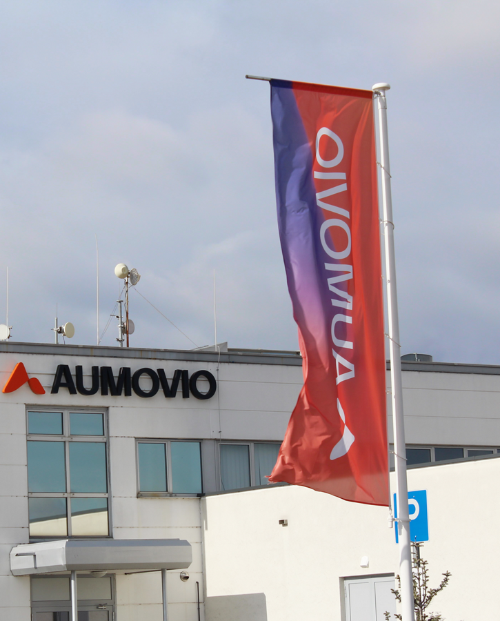 AUMOVIO Veszprem plant with AUMOVIO flag