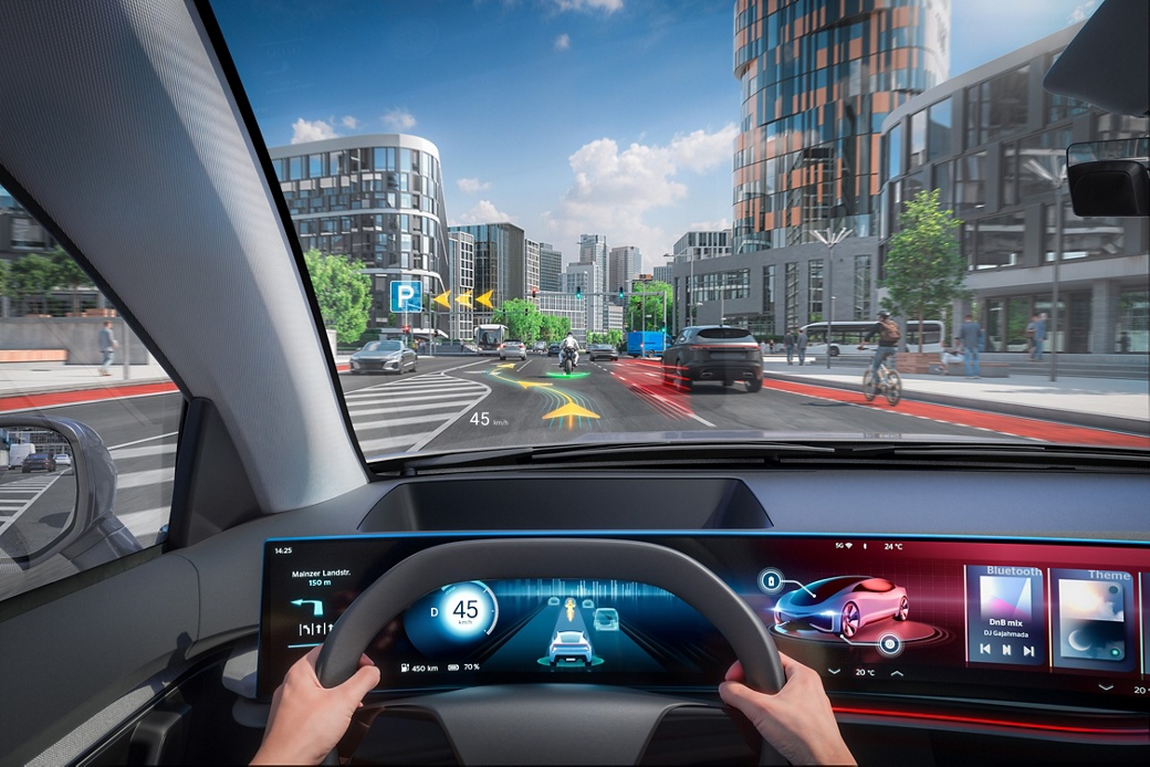 Driver's view from inside a car showing an augmented-reality head-up display with navigation arrows, speed and hazard markings projected onto a city street, plus a digital cockpit with navigation, speedometer and media controls