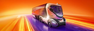 Futuristic autonomous concept truck speeding along a digital highway, surrounded by dynamic motion blur in orange, yellow, and purple light streaks against a vivid red-orange background.