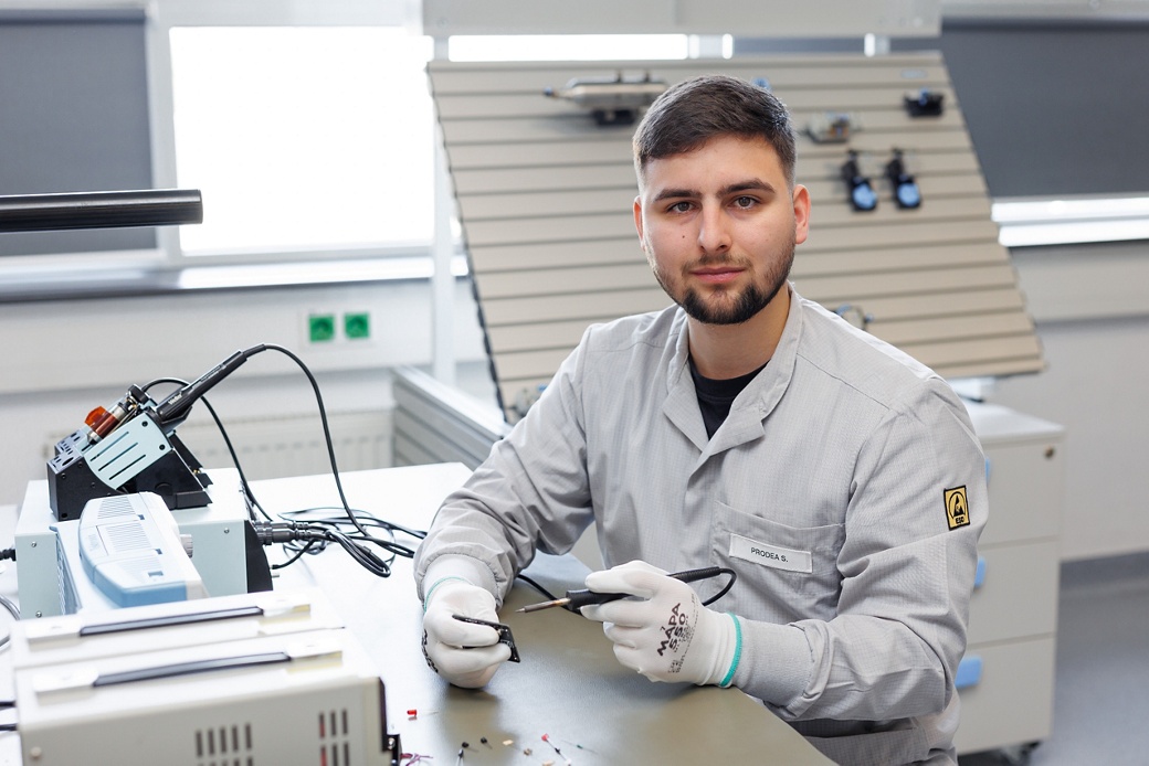 A male student in the Sibiu technical training lab