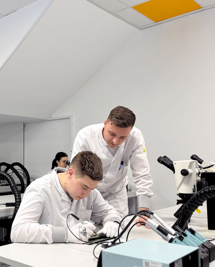3 pupils in a modern laboratory, engaged in hands on activities