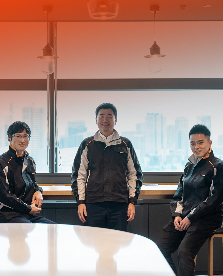 Parking team in meeting room standing in front of window.