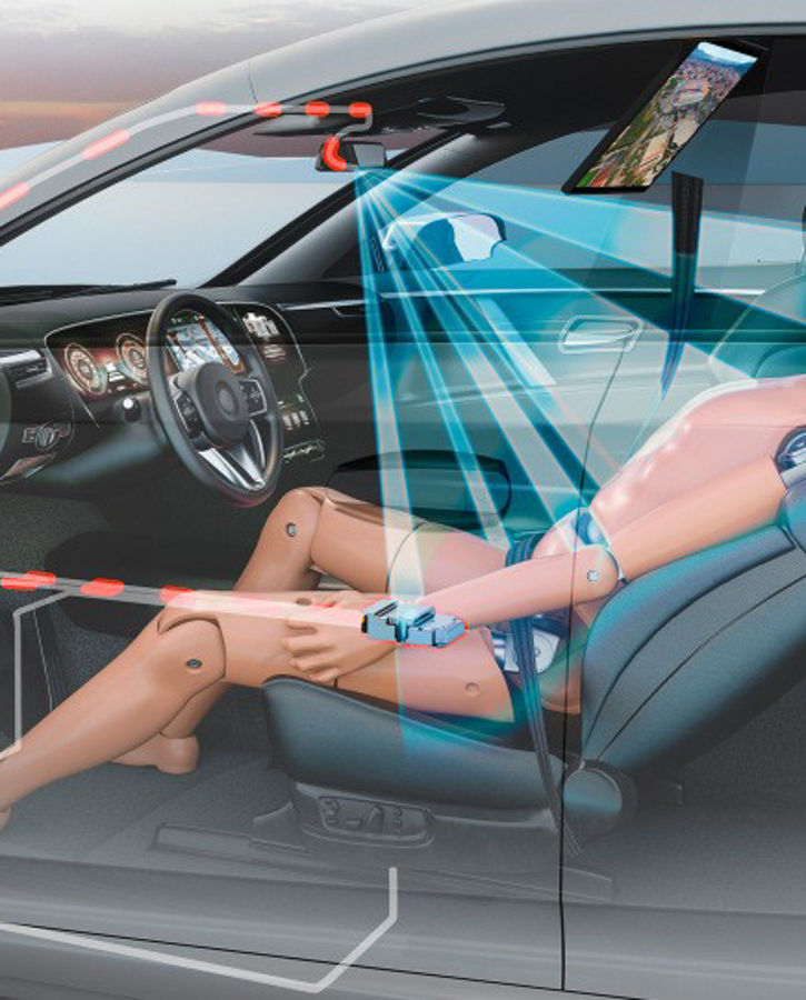 Interior view of a car with a transparent overlay showing an advanced occupant safety monitoring system. A crash test dummy is seated in a reclined position on the front passenger seat. Blue sensor beams project from the overhead camera toward the dummy, illustrating occupant detection and posture monitoring. Red circuit lines highlight the integration of safety electronics within the vehicle structure.
