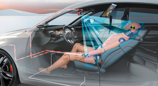 Interior view of a car with a transparent overlay showing an advanced occupant safety monitoring system. A crash test dummy is seated in a reclined position on the front passenger seat. Blue sensor beams project from the overhead camera toward the dummy, illustrating occupant detection and posture monitoring. Red circuit lines highlight the integration of safety electronics within the vehicle structure.
