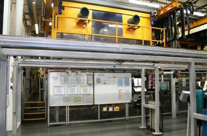 The image shows a large rack plating machine in a manufacturing facility. Rack plating is used because it is ideal for plating large batches of parts and those with more complex designs.