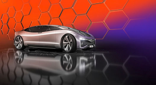 Futuristic silver concept car displayed against a vibrant orange and purple background with hexagonal patterns.