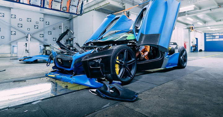 Image of a destroyed crash test vehicle after impact in a crash test facility