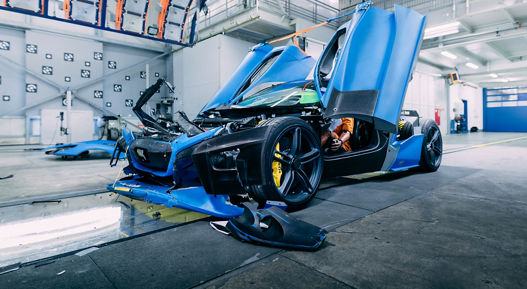 Image of a destroyed crash test vehicle after impact in a crash test facility