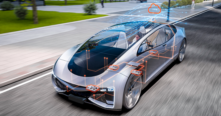 Futuristic silver car driving on an urban street with transparent overlays showing electronic architecture and server-zone connectivity. Orange circuit lines highlight key control units, while a cloud icon above the vehicle represents cloud-based data exchange and advanced software-defined vehicle technology.