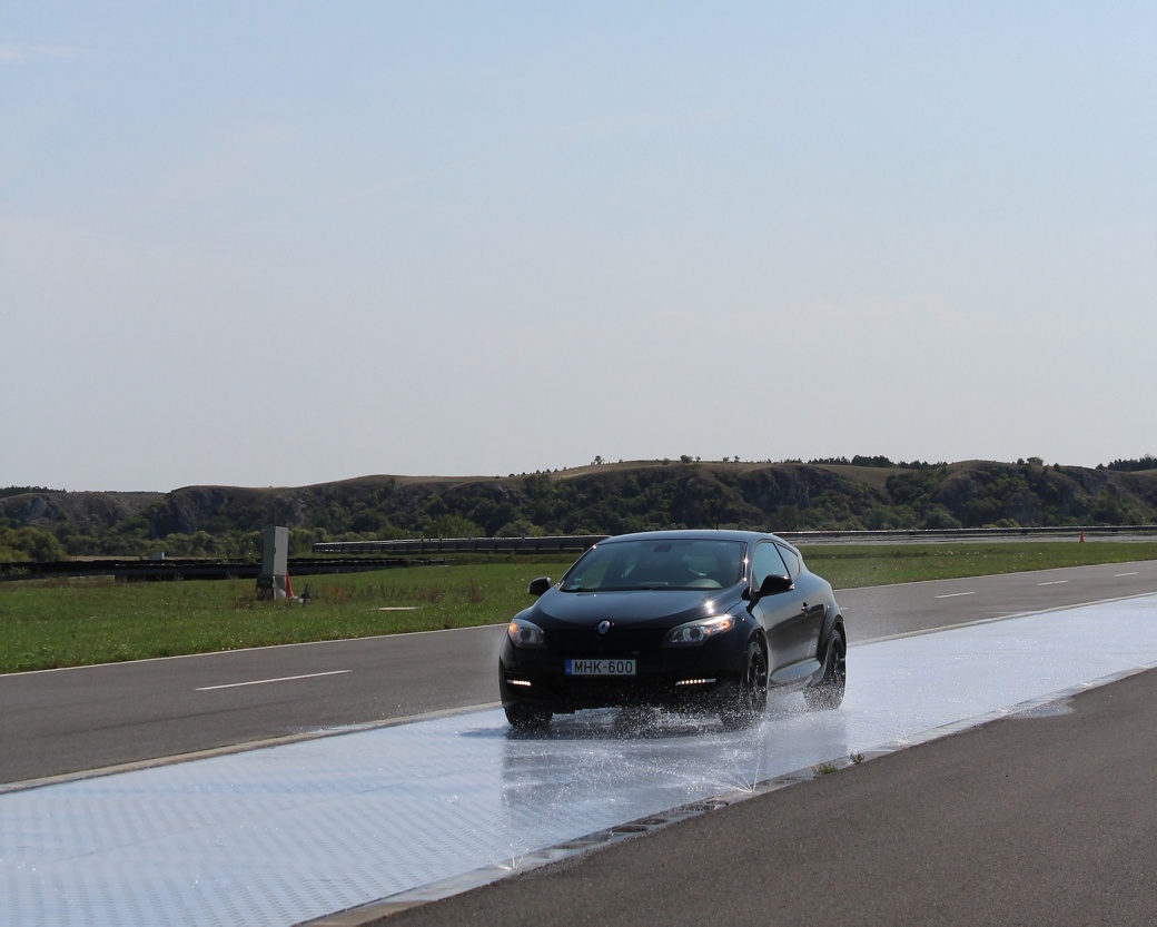 vehicle driving on wet surface for aquaplanning test