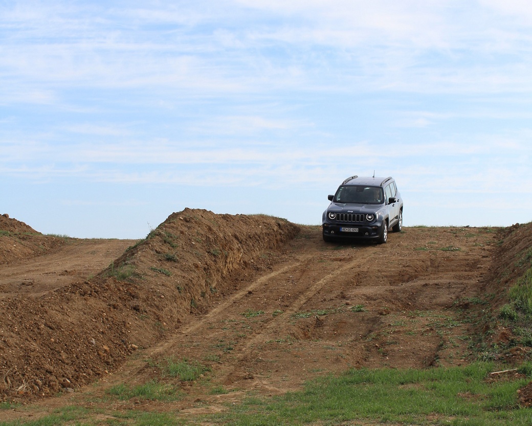 vehicle driving down earth hill