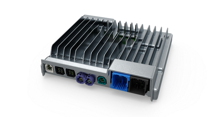 Close-up view of a smart cockpit high-performance computer (HPC) unit with a metallic housing and integrated cooling fins. The front side features multiple connectors in different colors, including black, purple, green, and blue, designed for data, power, and communication interfaces. The design emphasizes heat dissipation and robust connectivity for advanced in-vehicle systems.
