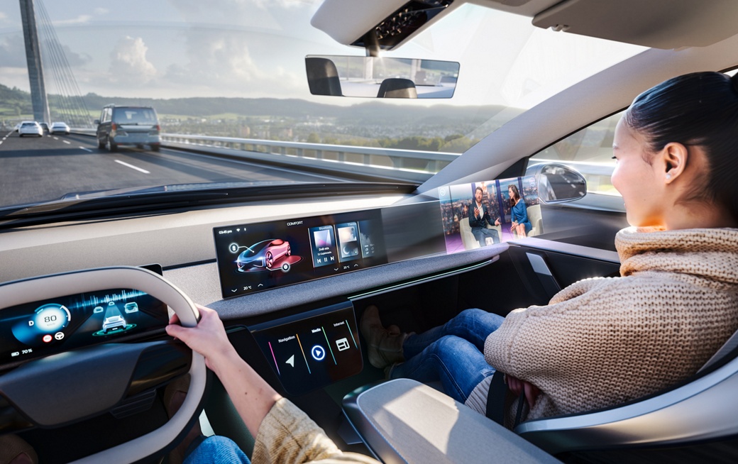 Image of a switchable partial privacy screen. The passenger enjoys digital content on a monitor in front of her without distracting the driver. Designed to minimize visual interference, Switchable Privacy Displays ensure the driver's attention remains fully on the road while co-drivers enjoy immersive entertainment.