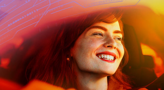 Beautiful young woman driving her new car at sunset. Woman in car. Close up portrait of pleasant looking female with glad positive expression, woman in casual wear driving a car