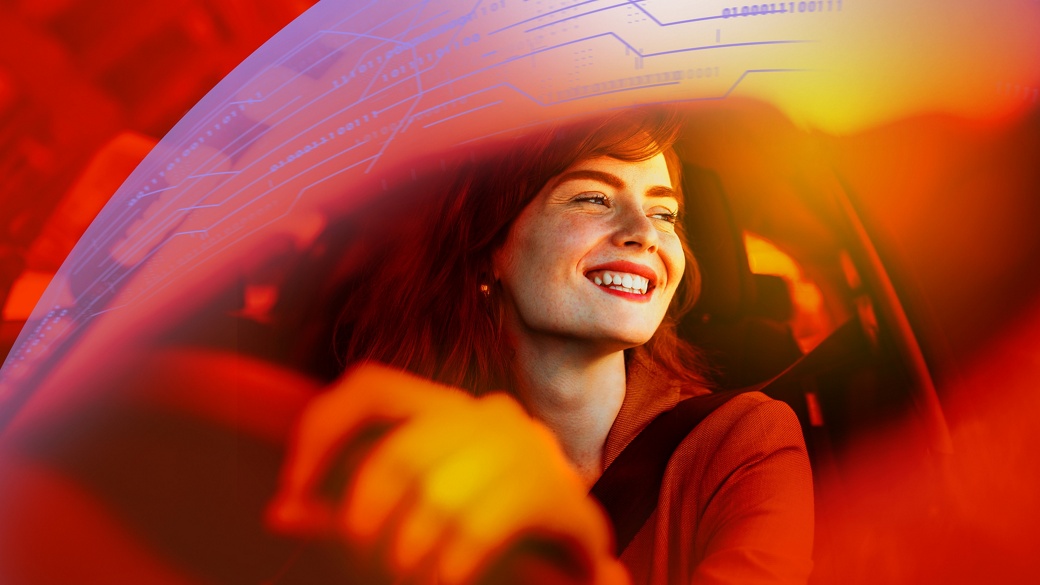 Beautiful young woman driving her new car at sunset. Woman in car. Close up portrait of pleasant looking female with glad positive expression, woman in casual wear driving a car