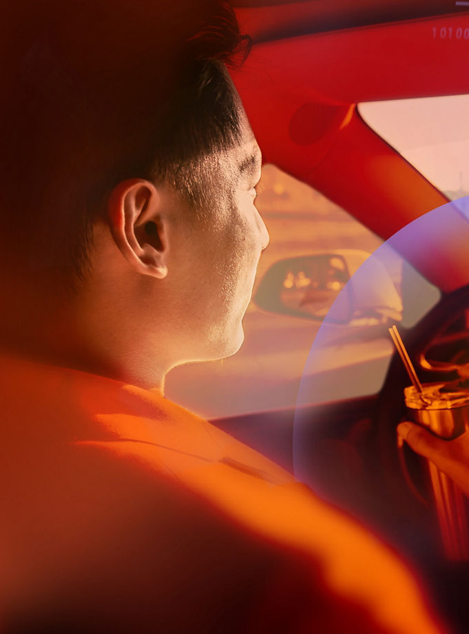 asian relaxed man use reusable eco-friendly ecological straw to drink while riding an autonomous self driving electric car and turn on autopilot function