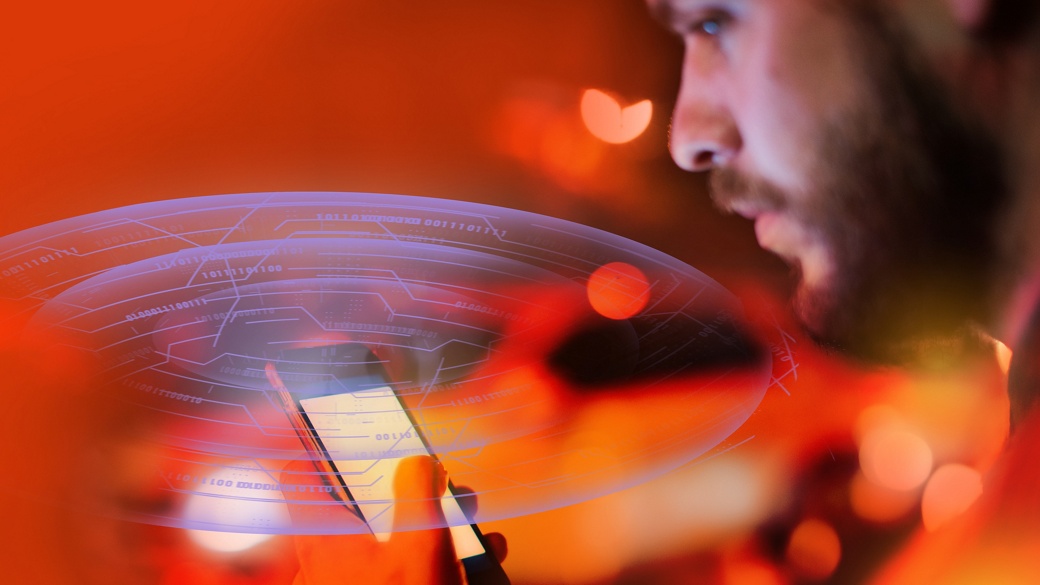 Close-up of a person using a smartphone with a futuristic digital interface overlay, set against a vibrant background of warm orange and red tones, symbolizing technology and connectivity..