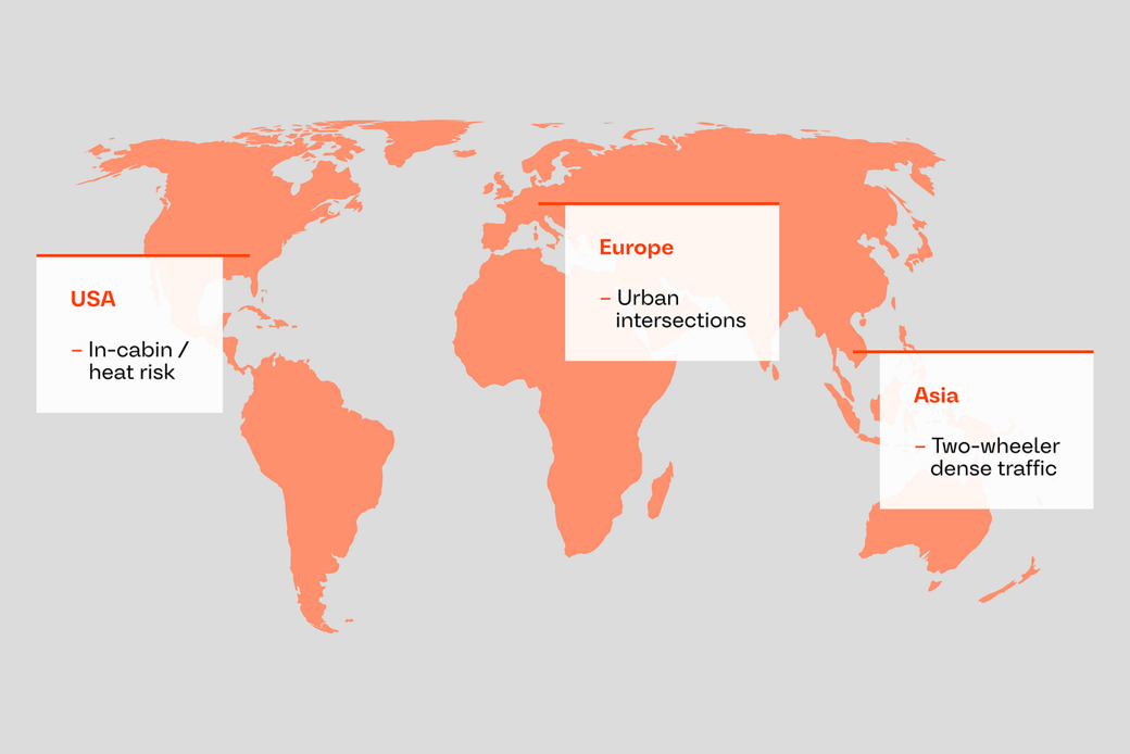 World map highlighting regional road safety challenges: in-cabin and heat risk in the USA, urban intersections in Europe, and dense two-wheeler traffic in Asia